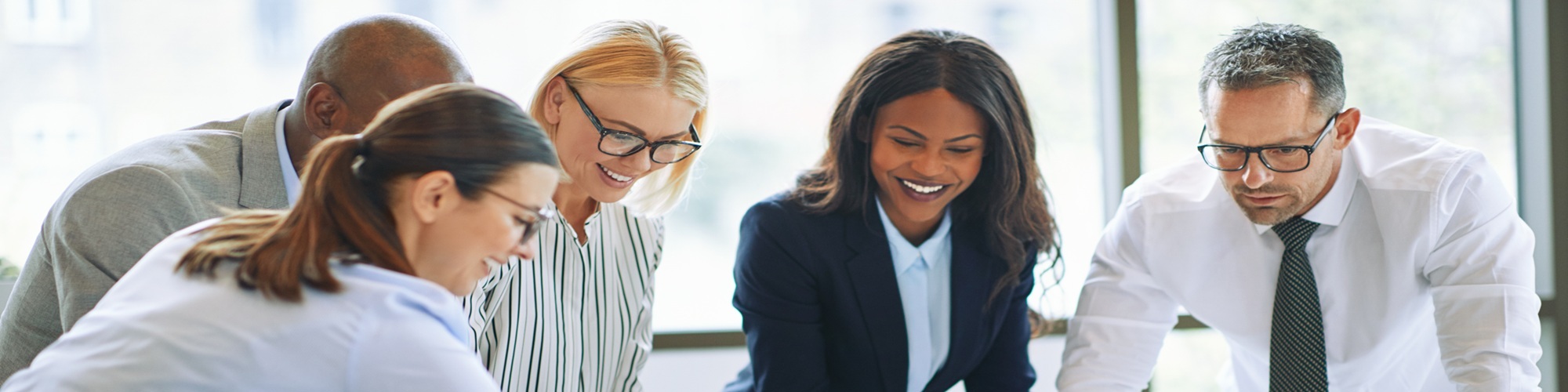 Smiling Businesspeople Solving A Jigsaw Puzzle In An Office Boar Smiling Businesspeople Solving A Jigsaw Puzzle In An Office Boar
